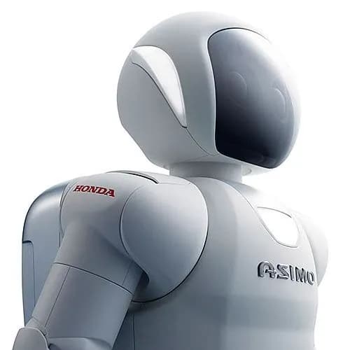 Крупный план ASIMO — белого робота с защитным щитком на лице и рюкзаком.